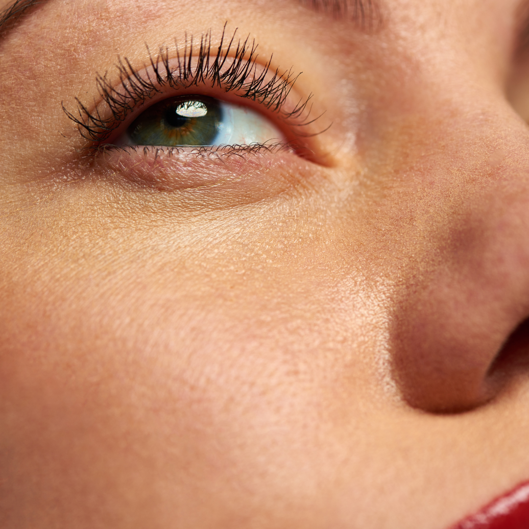 Zoomed image of woman's glowing face, with red lips after having used motherearth's magical mist
